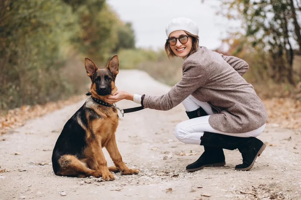 woman walking out with his German shepherd dog